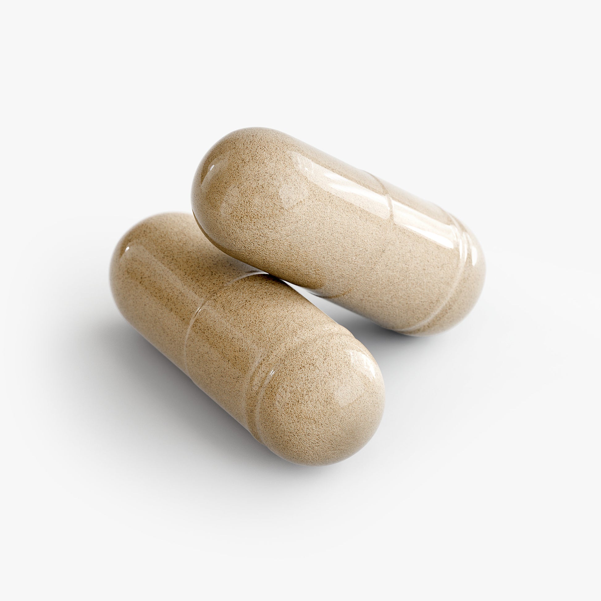 Two beige capsules on a white background